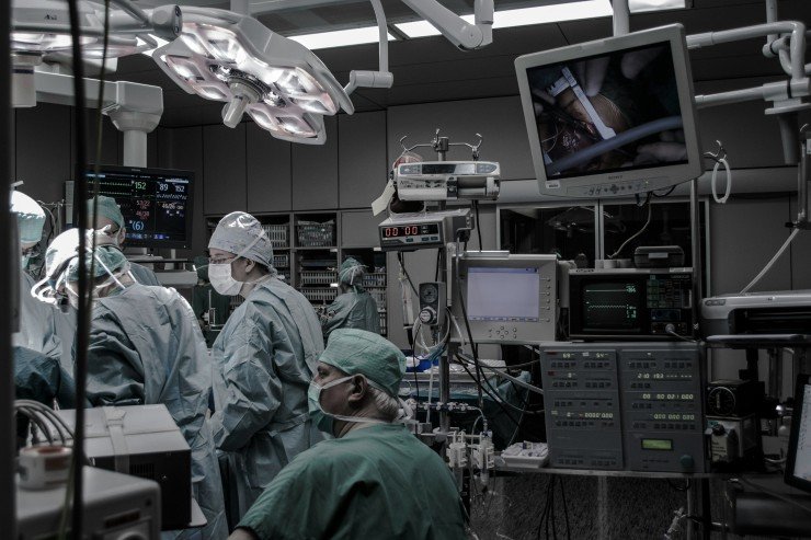 Advanced robotic-assisted surgery being performed by a skilled surgical team in a modern operating room.