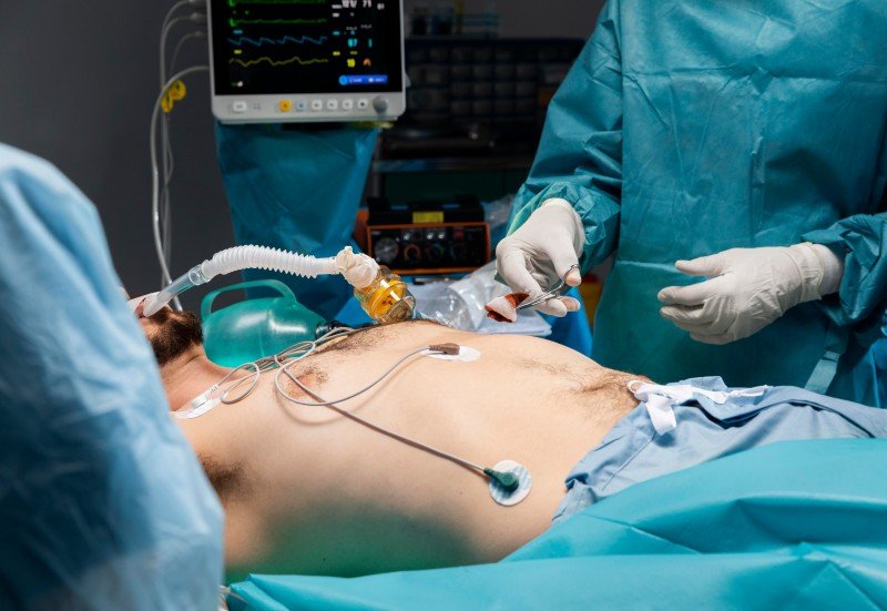 Patient undergoing laparoscopic weight loss surgery in a modern operating room with surgeons and advanced medical monitoring equipment.