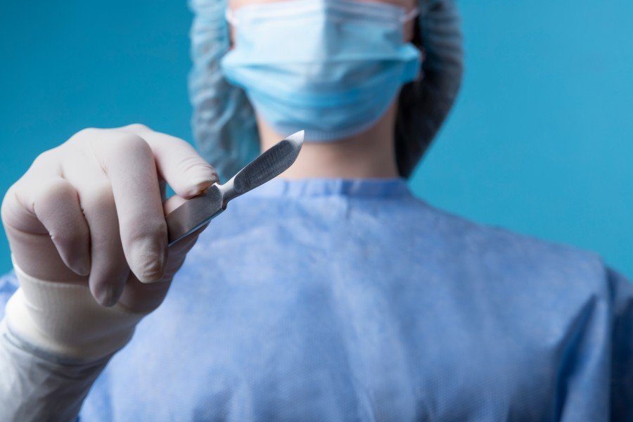 Female surgeon holding a surgical scalpel during a medical procedure