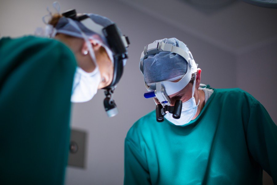 Surgeons performing a minimally invasive surgical procedure