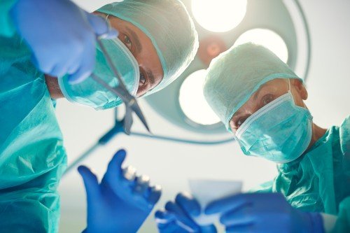 Surgeons performing Laparoscopic Weight Loss Surgery in a modern operating room.